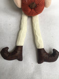 Harvest Gnome With Dangling Legs and Holding Knitted Pumpkin